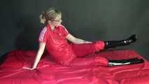 ***NEW MODELL MIA*** wearing a sexy red shiny nylon catsuit and black shiny rubber boots with heels during preparing her bed (Video)