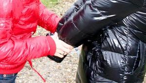 Beautiful archive girl tied and gagged outdoor by another one both wearing a shiny downjacket (Pics)