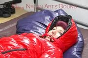 Mara tied and gagged on bed wearing a sexy shiny red down jacket and a blue rain pants (Pics)