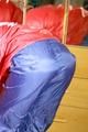 Sonja wearing a sexy red/blue rainwear combination during her workout (Pics)