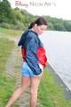 Sexy archive girl walking on a lake wearing a sexy shiny nylon shorts and an oldschool rain jacket (Pics)