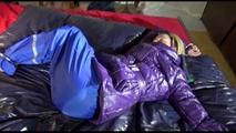 Sonja tied, gagged and hooded with cuffs on a bed wearing a sexy black blue pants and a purple down jacket (Video)