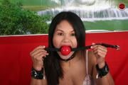 Restrained Asian is Gagged with Huge Ball Gag and Exposed in Humiliating Positions