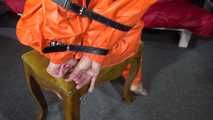 Sexy Pia wearing an oldschool orange shiny nylon rain pants and rain jacket being tied and gagged with belts and a ballgag on a chair (Video)