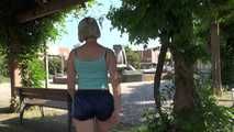 Watching SEXY SONJA walking through the city wearimg a blue shiny nylon shorts and tshirt (Video)