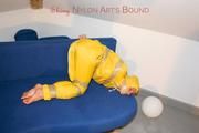 Archive girl tied and gagged by using tape on a sofa wearing an yellow rainsuit (Pics)
