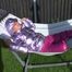 Watch Sandra enjoying her shiny nylon Downwear at a warm Summer Day in the Garden and in the Pool