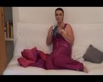 Jill putting on a sexy pink downwear skisuit and enjoy the feeling in it while reading a book and lolling on the sofa (Video)