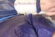 Mara tied and gagged on bed with ropes and a cloth wearing hot shiny nylon shorts and rain jacket (Pics)