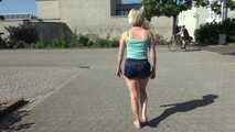 Watching SEXY SONJA walking through the city wearimg a blue shiny nylon shorts and tshirt (Video)