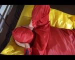 Lucy enjoying herself in shiny nylon rainwear double hooded on bed (Video)