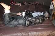 Watching sexy SONJA wearing a sexy black shiny nylon rain pants and a black shiny nylon down jacket being tied, gagged and hooded with ropes and a cloth gag on a bed (Pics) 