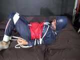 Watch Sandra hogtied and pantygagged in her shiny nylon Rainwear trying to free herself.