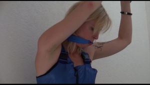 Pia tied and gagged on the stairway over her head wearing a supersexy shiny blue bib overall (Video) 