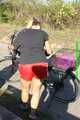 Watch Sandra riding her bike enjoying her red shiny nylon Shorts