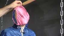 Watch Sandra bound gagged and wearing her shiny nylon Rainwear