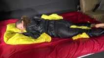 Sexy Sandra wearing sexy shiny nylon rainwear lolling in bed of nylon (Video)