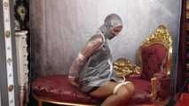 Miss Scarlett bound and gagged in full PVC outfit and transparent raincoat