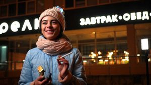 Lovely Russian girl Karina smokes a cigarette in the cold outside 