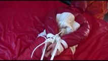 Mara tied, gagged and hooded on bed wearing a shiny red old school down jacket and pants (Video)