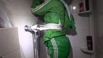 Sonja tied and gagged in a shower with tape and rope wearing a supersexy green shiny nylon shorts and rain jacket (Video)