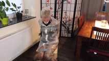 Miss Francine is bound and gagged in a nice short PVC dress covered with a transparent raincoat