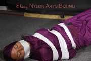 Sexy Sandra being tied, gagged and hooded with tape on the floor wearing a supersexy purple rain overall (Pics)