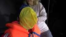 Watching Jill wearing a sexy shiny nylon rain pants and three shiny nylon rain jackets and a life jacket being tied and gagged and HOODED three times (Video)