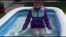 Watching Mara wearing a sexy short down skirt and a down jacket playing with water in the swimming pool (Video)