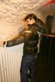 Jill tied and gagged on a heater wearing a shiny black down jacket and a darkblue rain pants (Pics)