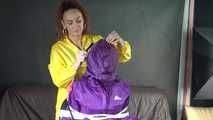 Watching sexy Sandra wearing hot purple shiny nylon rainwear with rubber boots being tied, gagged and hooded from Stella wearing a sexy yellow shiny nylon rainwear with high heels rubber boots (Video)