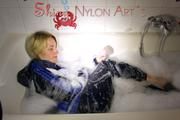 Sonja wearing a super sexy shiny nylon rain jacket and rain pants while taking a foam bath (Pics)