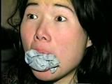 25 YEAR OLD ASIAN MAI-LING IS MOUTH STUFFED, CLEAVE GAGGED, HANDGAGGED, OTM GAGGED, TAPE GAGGED & TIGHTLY TIED TO A CHAIR  (D47-15)