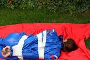 Nicole in an blue sauna suit tied and gagged in the garden (Pics)