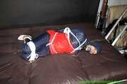 Watch Sandra bound gagged wearing her shiny nylon Rainwear