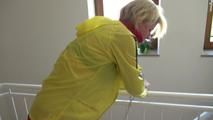 Pia wearing a red/yellow shiny nylon shorts and a yellow rain jacket while tied and gagged on a stairway with cuffs (Video)