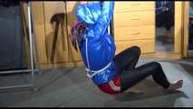 Sonja tied with ropes overhead and gagged with a clothgag wearing sexy black leather pants with a red shiny nylon shorts over it and a special blue down jacket (Video)