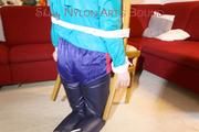 Mara tied and gagged and hooded on a chair wearing sexy shiny nylon shorts over a rainpants and a rain jacket (Pics)