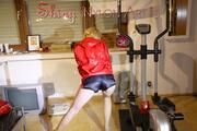 Sonja wearing a sexy blue shiny nylon shorts and a rain jacket while stretching herself at home (Pics)