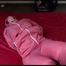 Jill tied, gagged and hooded on a bed wearing sexy pink shiny rainwear (Video)