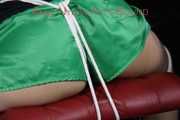 Watching sexy Sandra wearing a sexy green shiny nylon shorts and a black top being tied and gagged with ropes and a clothgag on a chair (Pics)