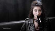 Dark-haired goddess experimenting with a cigarette holder while posing on camera