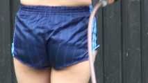 Watching Ayiana wearing  only a sexy blue shiny nylon shorts watering the flowers (Video)