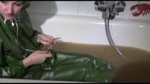 Mara wearing a sexy green shiny pvc jumpsuit with hood ties and gagges herself in a bath tub full of mud (Video)