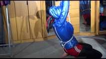 Sonja tied with ropes overhead and gagged with a clothgag wearing sexy black leather pants with a red shiny nylon shorts over it and a special blue down jacket (Video)