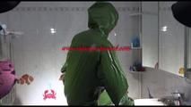 Mara wearing a sexy green shiny pvc jumpsuit with hood ties and gagges herself in a bath tub full of mud (Video)