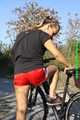 Watch Sandra riding her bike enjoying her red shiny nylon Shorts