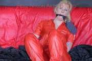 Pia tied and gagged with nack ties on a bed wearing a sexy red shiny nylon rainwear catsuit (Pics)