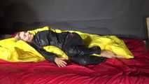 Sexy Sandra wearing sexy shiny nylon rainwear lolling in bed of nylon (Video)