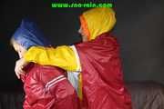 Watching sexy Sandra and Stella putting on several hot shiny nylon rainwear (Pics)